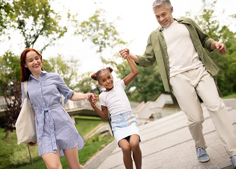 Foster Parent Intervention Rights - Foster parents holding hands with foster child, spending family time together - adoption - Springfield, IL