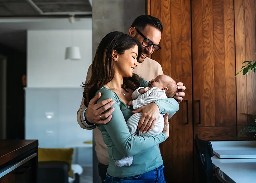 Private Adoption - Young husband and wife holding a newborn baby that they just adopted privately. - Springfield, IL