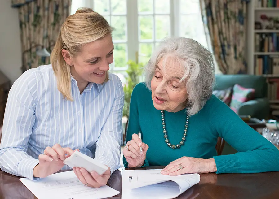 Power of Attorney Property - Adult women helping her older mother pay bills because she is her mothers power of attorney over her property. - Springfield, IL