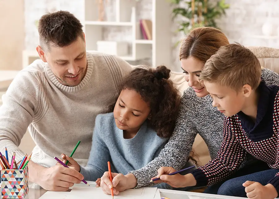 DCFS Adoption - family coloring together with a child they just adopted from DCFS - champaign il