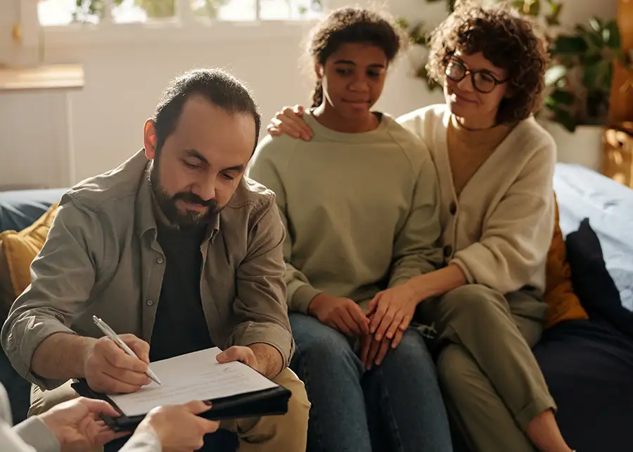 Foster parents working with social worker and teen child to plan how best to resolve DCFS identified issues - bloomington il
